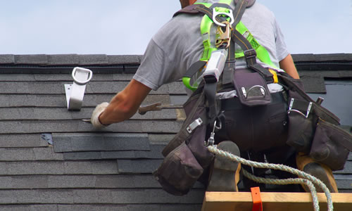 Roofer repairing felt tiles